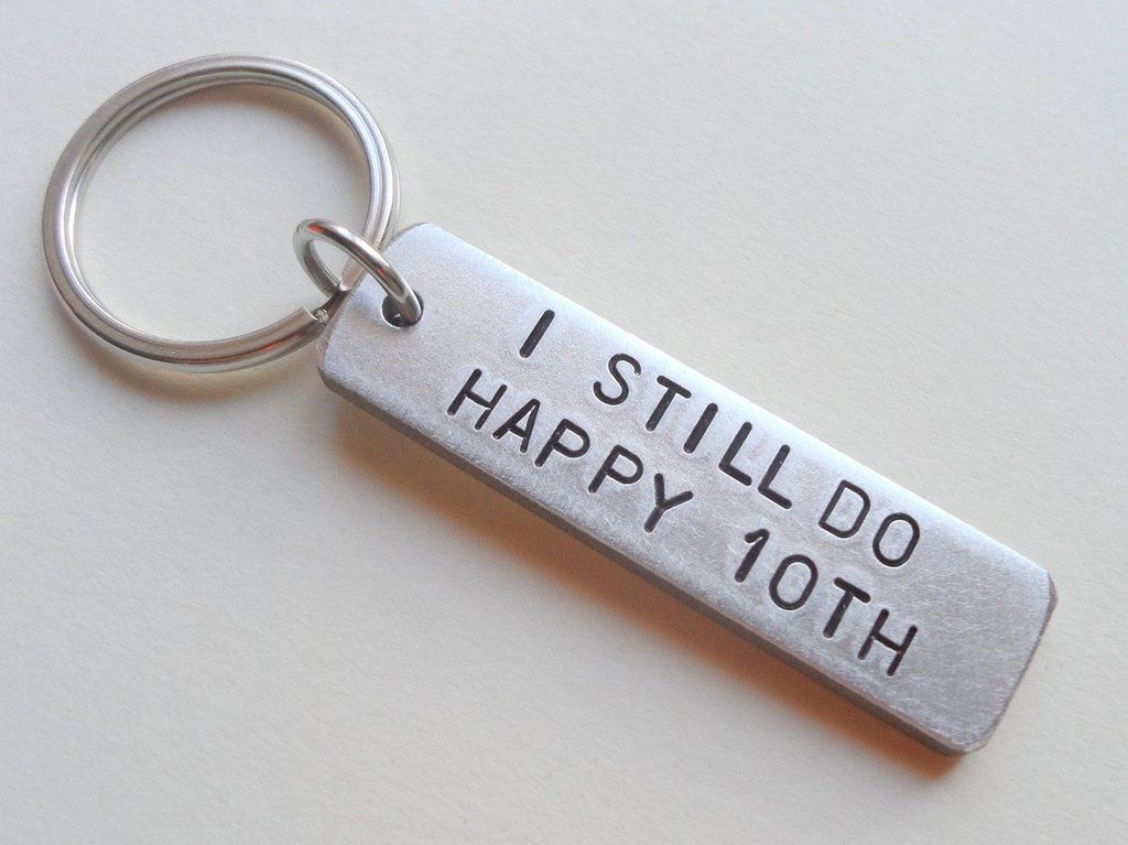 This is a key chain made from aluminium showing the tenth year wedding anniversary gift - traditional wedding gifts